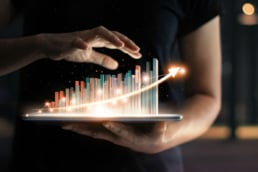 A tablet with a holographic chart rising out of it