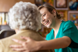woman nurse helping elderly patient