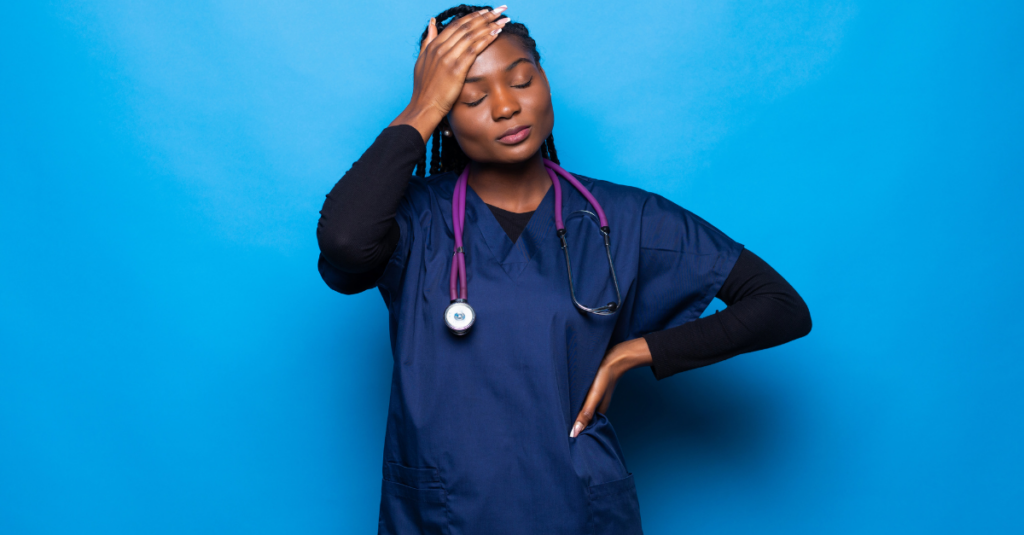 Nurse stands in front of a blue background with hand on her head showing how nurse mental health can suffer because of the job