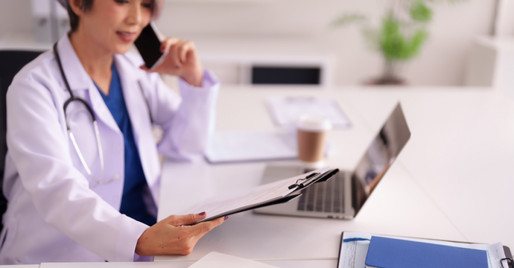 Physician looking at paper and utilizing labor forecasting and per diem staffing to account for busy season.