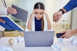 Shot of a young healthcare clinician looking overwhelmed in a demanding work environment